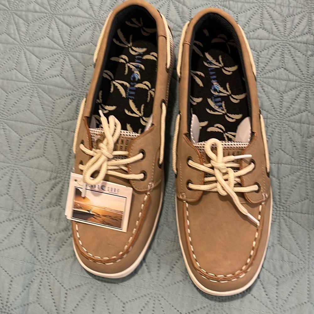 Sanibel tan deck shoes . New in box. Never worn.